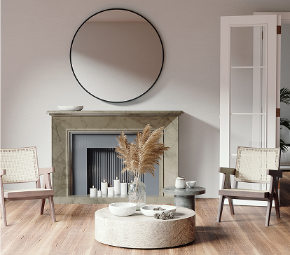 Un salon avec deux fauteuils en bois, une table basse ronde, un vase de pampas, et un miroir rond au-dessus d'une cheminée.