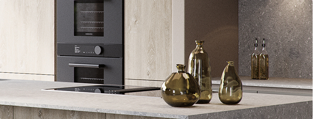 Des bouteilles en verre ambré sont posées sur un plan de travail en pierre grise, avec un four encastré noir en arrière-plan.